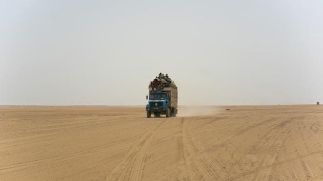 A truck carrying migrants drives through the Saharan Tenere in Niger. Once a well-worn roadway for tourists, the highway’s 4,500 kms are a favoured path for migrants heading north. Here in the desert, Algeria has abandoned more than 13,000 people in the past 14 months, including pregnant women and children, stranding them without food or water and forcing them to walk, under temperatures of up to 48 degrees Celsius. (Jerome Delay / AP)