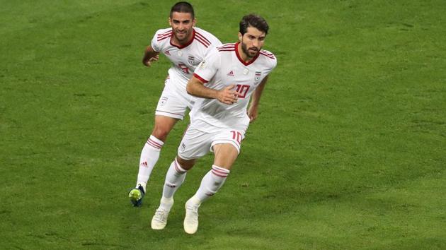 Iran's Karim Ansarifard (R) celebrates scoring equalising goal from the penalty spot. (REUTERS)