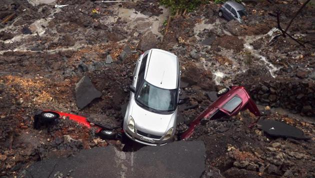 The landslide buried six cars in the parking lot on Monday. (PTI) The landslide buried six cars in the parking lot on Monday. (PTI)