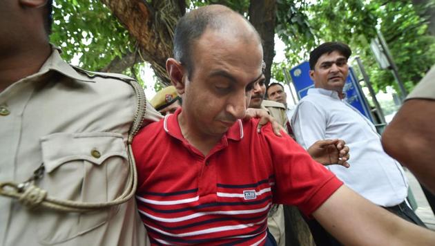 Accused Army Major Nikhil Rai Handa being taken by police to be produced at Patiala Court, after his arrest in relation with the alleged murder of a fellow army Major's wife, in New Delhi on Monday.(PTI Photo)