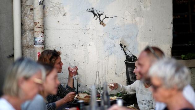 This second of three rat themed pieces shows a rodent case flying through the air, riding the cork from a champagne bottle. Meanwhile diners sip on their drinks in the foreground –a fitting placement. (Benoit Tessier / REUTERS)