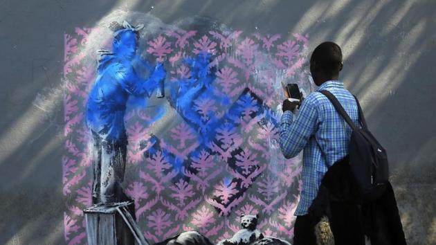 The painting was subsequently defaced to make it look like she was painting the Nazi symbol herself. Lacking the security of museums or galleries, these public pieces are prone to damage, and have already begun witnessing attempts to alter, deface or reserve them. (Thibault Camus / AP)