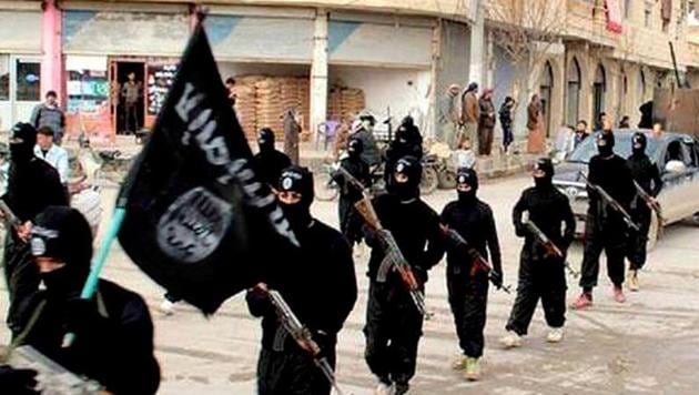 Islamic State fighters take out a march in Syria. Eleven Keralites who went missing from Dubai are believed to have joined the terror outfit.(AP File Photo) Islamic State fighters take out a march in Syria. Eleven Keralites who went missing from Dubai are believed to have joined the terror outfit.(AP File Photo)