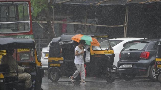 Commuters brave the rain at Versova, Mumbai on Tuesday. Karnataka also experienced another round of heavy rain after last week, leading to flooding of arterial roads and national highways in the cities and affecting vehicular movement in the state’s coastal regions. (Satyabrata Tripathy / HT Photo)