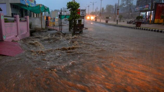A view of a flooded road during heavy rain, in Rajasthan’s Dungarpur on Monday. The district recorded 15 to 19 cm rainfall, whereas various places across the state recorded rainfall ranging from 1 to 12 cm yesterday. (PTI)