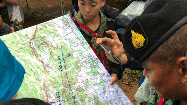 Soldiers read a map near the cave during a search of the team along with their coach. The football team and their coach planned to explore the cave, even though it is known to be prone to flooding in the rainy season, and had taken flashlights and some food, according to messages they exchanged. (Chayut Setboonsarng / REUTERS) Soldiers read a map near the cave during a search of the team along with their coach. The football team and their coach planned to explore the cave, even though it is known to be prone to flooding in the rainy season, and had taken flashlights and some food, according to messages they exchanged. (Chayut Setboonsarng / REUTERS)