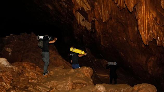 Navy SEAL divers equipped with oxygen tanks and food rations entered the cave early Tuesday, as light rains continued to fall. (Krit Phromsakla Na Sakolnakorn / AFP) Navy SEAL divers equipped with oxygen tanks and food rations entered the cave early Tuesday, as light rains continued to fall. (Krit Phromsakla Na Sakolnakorn / AFP)