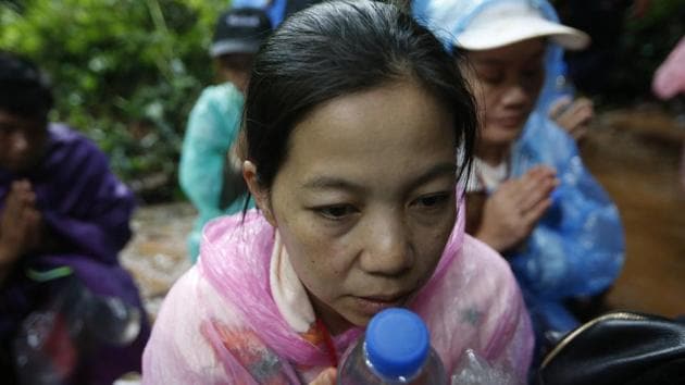 Distraught relatives of the teenaged members of the soccer team turned to prayers as caving enthusiasts helped military rescue teams on the third day of the search. (Sakchai Lalit / AP) Distraught relatives of the teenaged members of the soccer team turned to prayers as caving enthusiasts helped military rescue teams on the third day of the search. (Sakchai Lalit / AP)
