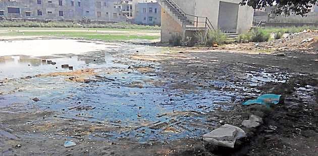 Due to choked sewerage on Ram Tirath road water enters into the playground of SL Bawa College in Batala.(HT Photo)