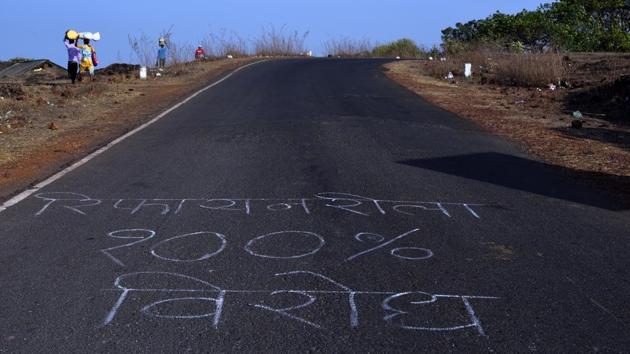 Farmers and residents have chalked roads all along the border of Sindhudurg and Ratnagiri districts in Maharashtra, with “The refinery will not be constructed here.(Anshuman Poyrekar / HT Photo)