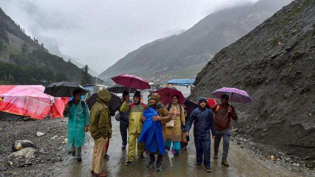 Around 3,000 Amarnath Yatra pilgrims, who had arrived at base camps in central Kashmir’s Baltal and south Kashmir’s Pahalgam from Jammu, have been asked to stay put in their tents. “All the yatris are requested not to queue up outside the gate. They won’t be allowed to move ahead today as the track has become slippery due to rains”, officials announced on loudspeakers at Baltal camp. (S Irfan / PTI) Around 3,000 Amarnath Yatra pilgrims, who had arrived at base camps in central Kashmir’s Baltal and south Kashmir’s Pahalgam from Jammu, have been asked to stay put in their tents. “All the yatris are requested not to queue up outside the gate. They won’t be allowed to move ahead today as the track has become slippery due to rains”, officials announced on loudspeakers at Baltal camp. (S Irfan / PTI)