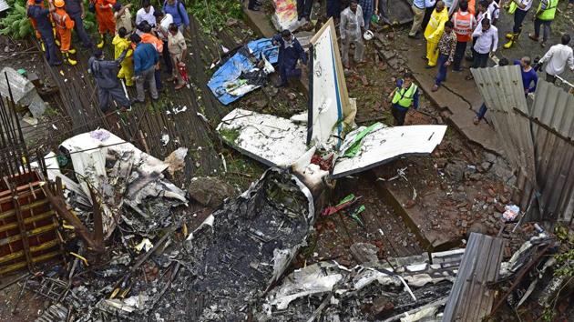 Forensic experts, fire department personnel and a dog squad inspect the crash site of a chartered plane at Old Malik Estate, Jeev Daya Lane, Ghatkopar, in Mumbai on June 28, 2018.(Vijayanand Gupta/HT Photo)