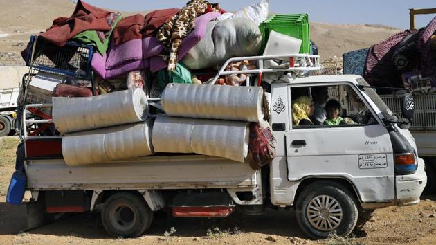 The small exodus is part of a repatriation program that the Lebanese government says is voluntary. Khaled Abdul-Aziz, a Syrian who heads a committee for the returnees, said 472 Syrians were expected to make the crossing after requesting permission from the Lebanese and Syrian governments. They are part of a total of 3,194 Syrians who have registered to return, he said. (Bilal Hussein / AP)