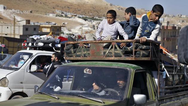 Syrian refugees in a pickup truck get ready to cross into Syria. The UN refugee agency “is fully respectful of the decision of the Lebanese government and we fully respect the decision of the families to return. We don’t interfere,” said Josep Zapater, head of the UNHCR office in Lebanon’s eastern Bekaa Valley. (Bilal Hussein / AP)
