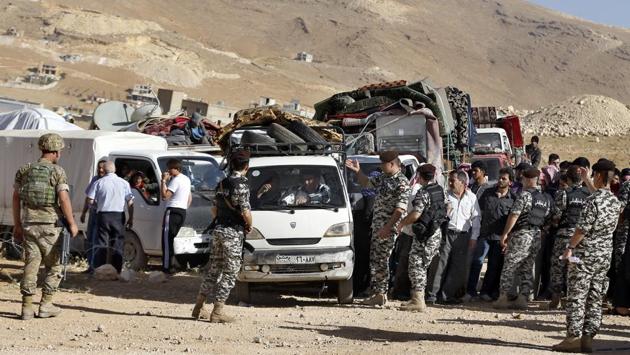 The refugees seen gathered in the Wadi Hmeid area of Arsal, where Lebanese security officers check their IDs against a list before allowing passage into Syria. Lebanon’s general security chief Abbas Ibrahim said that the UNHCR has been notified about the return of the Syrians “so they can bear their responsibility.” (Bilal Hussein / AP)