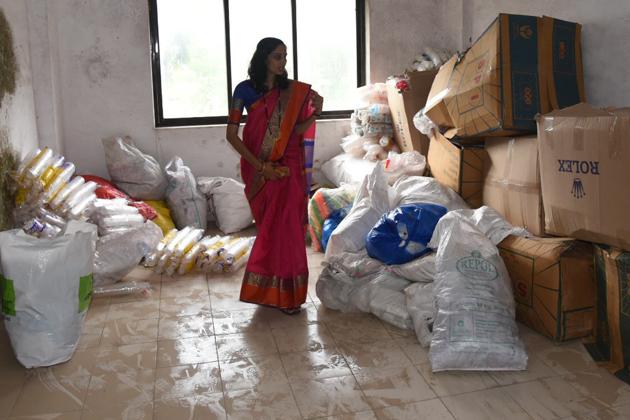 Tejaswini Galande from PCMC inspects plastic collected at one of the centres(Bachchan Kumar/HT)