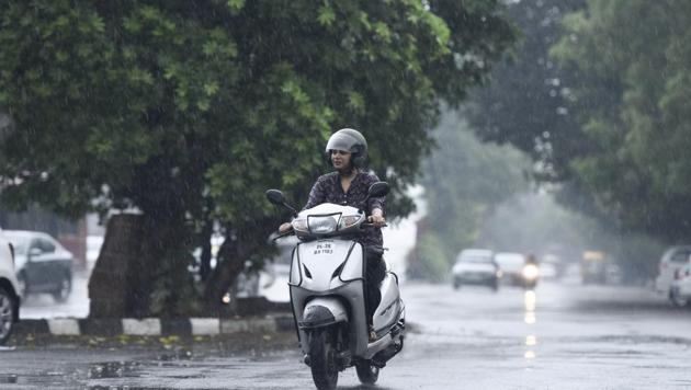 A woman rides a scooter during the pre-monsoon showers, near Sheikh Sarai in New Delhi. (Burhaan Kinu/HT Photo) A woman rides a scooter during the pre-monsoon showers, near Sheikh Sarai in New Delhi. (Burhaan Kinu/HT Photo)