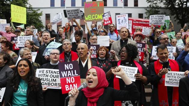 Varisha Khan (front, centre), director of the Muslim committee at OneAmerica in Seattle, leads a chant during a protest & news conference by CAIR-Washington and other organizations upset by the Supreme Court's decision in downtown Seattle. The 5-4 ruling, with the court’s five conservatives in the majority, ended a fierce fight in the courts over whether the policy amounted to an unlawful Muslim ban. (Ken Lambert / The Seattle Times via AP)