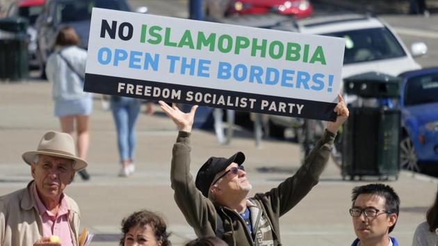 Bob Price holds up a sign as affected community members speak about the Supreme Court decision during a news conference outside the City Hall in San Francisco. (Eric Risberg / AP)