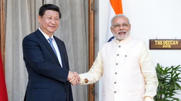 Prime Minister Narendra Modi, right, shakes hands with Xi Jinping, China's president, as they arrive for delegation talks at Hyderabad House in New Delhi, India, on Thursday, September 18, 2014.(Graham Crouch/Bloomberg)