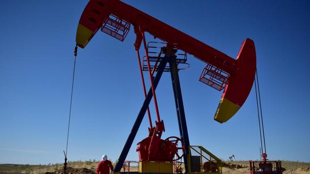 A worker inspects a pump jack at an oil field in Tacheng, Xinjiang Uighur Autonomous Region, China.(REUTERS File Photo)