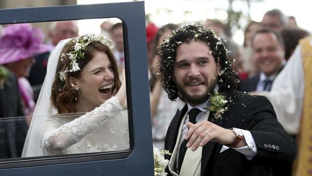 Actors Kit Harington and Rose Leslie react as they leave after their wedding ceremony, at Rayne Church, Kirkton of Rayne in Aberdeenshire, Scotland. (Jane Barlow / PA via AP) 