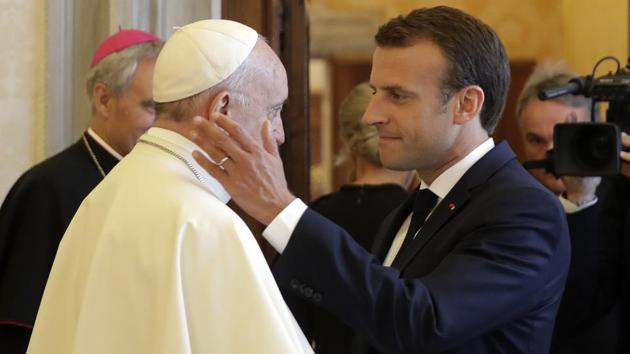 French President Emmanuel Macron (R), goes in to hug Pope Francis at the end of their private audience, at the Vatican. (Alessandra Tarantino / Pool Photo via AP) 