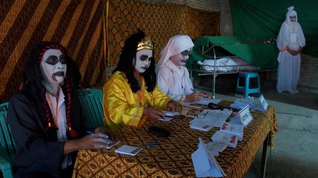 Election officials dress as ghosts at a polling station for local elections in Randusari village, Semarang, Central Java, Indonesia. (R. Rekotomo / Antara Foto via REUTERS) 
