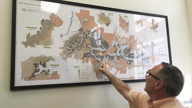 Greg Jones, an authority on climate change and wines, looks over a map of the Willamette Valley viticultural area, the venue for the VitiNord wine conference, which will examine cooler-climate wine production. “If you’re growing grapes in a given environment today with what we have going on out there, you should be trying other varieties in small numbers to see how they perform,” Jones said. (Andrew Selsky / AP) Greg Jones, an authority on climate change and wines, looks over a map of the Willamette Valley viticultural area, the venue for the VitiNord wine conference, which will examine cooler-climate wine production. “If you’re growing grapes in a given environment today with what we have going on out there, you should be trying other varieties in small numbers to see how they perform,” Jones said. (Andrew Selsky / AP)