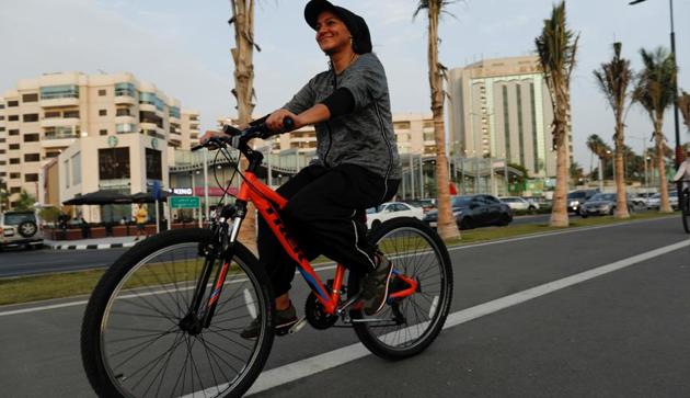 Eman Joharjy, a fashion designer in one of her own creations, cycles along Jeddah's Corniche. (REUTERS) Eman Joharjy, a fashion designer in one of her own creations, cycles along Jeddah's Corniche. (REUTERS)