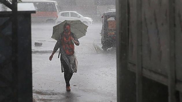 A woman caught in the rains in Jaipur. (Himanshu Vyas/HT Photo) A woman caught in the rains in Jaipur. (Himanshu Vyas/HT Photo)