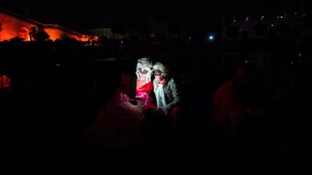 Participants dressed in costumes as those worn in Versailles during King Louis XIV period attend the “Grand Bal Masque” (Grand Masquerade) in the Versailles Castle, France. (Philippe Wojazer / REUTERS) 