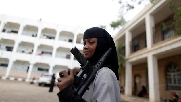 A girl displaced by the fighting in the Red Sea port city of Hodeidah holds a toy rifle at a school where IDPs live in Sanaa, Yemen. (Khaled Adbullah / REUTERS) 