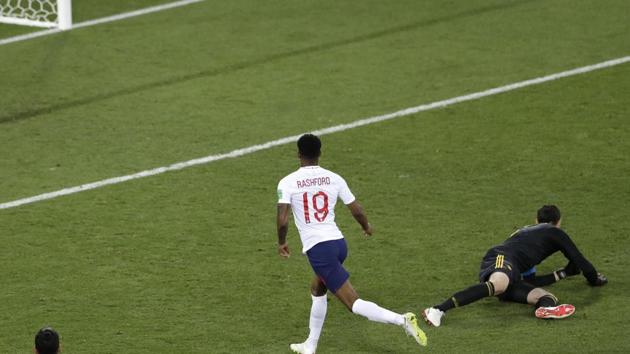 England's Marcus Rashford, front, fails to score past Belgium goalkeeper Thibaut Courtois during the group G match between England and Belgium. (AP)