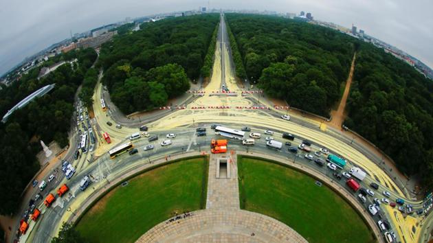 A fish-eye view shows workers cleaning the street after Greenpeace activists painted it yellow in a protest to call for quick exit to coal fired power in Berlin, Germany. (Hannibal Hanschke / REUTERS) 