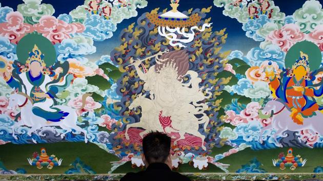 Exile Tibetan artist Tenzin Yeshi, 29, paints a traditional painting called 'thangka' in Dharmsala on June 27, 2018. (Ashwini Bhatia / AP) Exile Tibetan artist Tenzin Yeshi, 29, paints a traditional painting called 'thangka' in Dharmsala on June 27, 2018. (Ashwini Bhatia / AP)