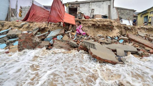 A woman sits near her partially damaged house which collapsed due to seawater incursion along the coast of Srinivasapuram in Pattinapakkam, Chennai on June 27, 2018. (PTI) A woman sits near her partially damaged house which collapsed due to seawater incursion along the coast of Srinivasapuram in Pattinapakkam, Chennai on June 27, 2018. (PTI)