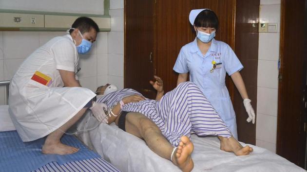 In this photo released by Xinhua News Agency, hospital workers attend to a person injured in a coach-truck collision accident in Hengdong County, central China's Hunan Province, Saturday, June 30, 2018. P(AP Photo) In this photo released by Xinhua News Agency, hospital workers attend to a person injured in a coach-truck collision accident in Hengdong County, central China's Hunan Province, Saturday, June 30, 2018. P(AP Photo)