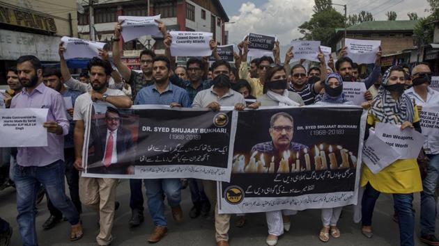 Kashmiri journalists hold banners and placards as they march during a protest against the killing of senior journalist Shujaat Bukhari in Srinagar on June 26, 2018. (Dar Yasin / AP) Kashmiri journalists hold banners and placards as they march during a protest against the killing of senior journalist Shujaat Bukhari in Srinagar on June 26, 2018. (Dar Yasin / AP)