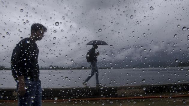 Rain drops are seen on the window glass of a car as Kashmiri men walk on the shore of Dal Lake in Srinagar on June 29, 2018. (Dar Yasin / AP) Rain drops are seen on the window glass of a car as Kashmiri men walk on the shore of Dal Lake in Srinagar on June 29, 2018. (Dar Yasin / AP)
