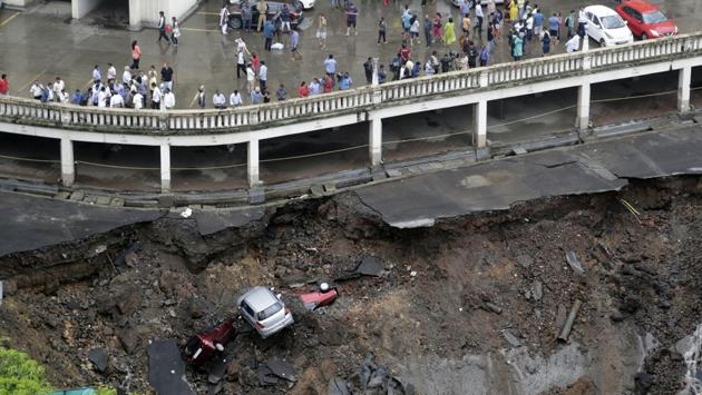 Cars lie buried in debris after the wall of an under construction building collapsed during heavy rains in Mumbai on June 25, 2018. (Rajanish Kakade / AP) Cars lie buried in debris after the wall of an under construction building collapsed during heavy rains in Mumbai on June 25, 2018. (Rajanish Kakade / AP)