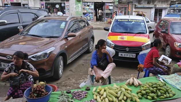 Women vendors display their wares, in front of a car painted in the colours of Spain’s flag, in Kohima. What explains this love of football? No one is sure. Maybe it came from the Christian missionaries who arrived in the 19th century. Some inspiration probably came from the British. For Nagaland, Talimeren Ao, a small-town doctor and captain of India’s 1948 Olympic team, played inspiration to generations of players. (Yirmiyan Arthur / AP) Women vendors display their wares, in front of a car painted in the colours of Spain’s flag, in Kohima. What explains this love of football? No one is sure. Maybe it came from the Christian missionaries who arrived in the 19th century. Some inspiration probably came from the British. For Nagaland, Talimeren Ao, a small-town doctor and captain of India’s 1948 Olympic team, played inspiration to generations of players. (Yirmiyan Arthur / AP)