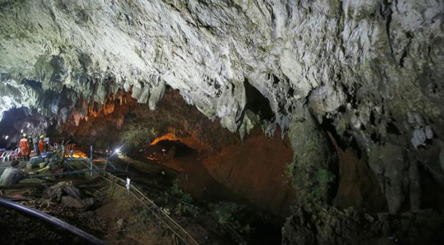 Rescuers work at the entrance to a cave complex where 12 soccer team members and their coach went missing, in Mae Sai, Chiang Rai province, in northern Thailand, on June 30, 2018.(AP) Rescuers work at the entrance to a cave complex where 12 soccer team members and their coach went missing, in Mae Sai, Chiang Rai province, in northern Thailand, on June 30, 2018.(AP)