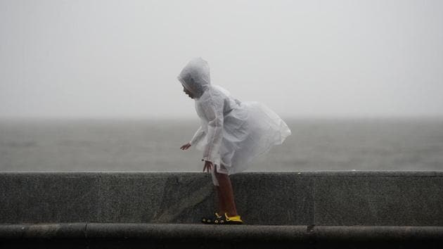 A child walks along the sea front during heavy monsoon showers in Mumbai on June 25, 2018. (Punit Paranjpe / AFP) A child walks along the sea front during heavy monsoon showers in Mumbai on June 25, 2018. (Punit Paranjpe / AFP)