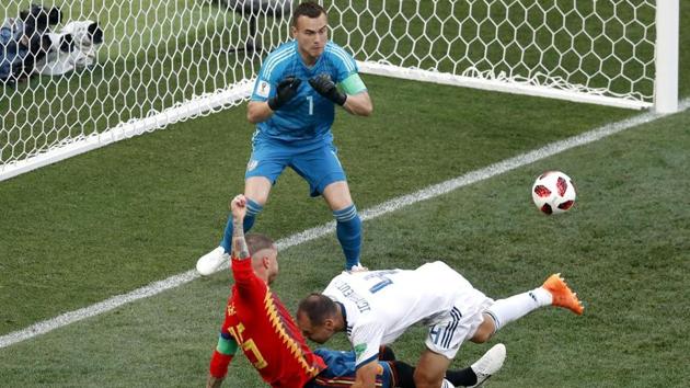 Sergei Ignashevich conceded an own goal as Spain took the lead against Russia. (AFP)