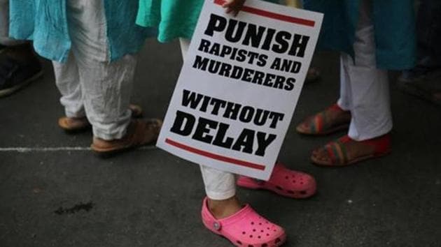 A protestor stands with a placard during a protest rally against rapes in India, in New Delhi.(AP File Photo)