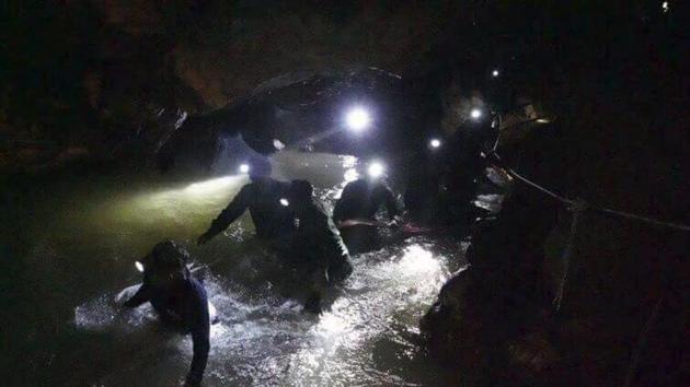 Thai rescue teams walk inside cave complex where 12 boys and their soccer coach went missing, in Mae Sai, Chiang Rai province, in northern Thailand on July 2.(AP Photo)