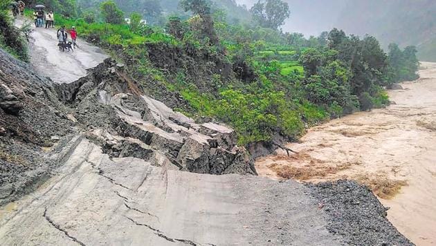 A road leading to Rasiyabad village washed away after heavy rainfall at Munsiyari in Pithoragarh district on Monday.(PTI)