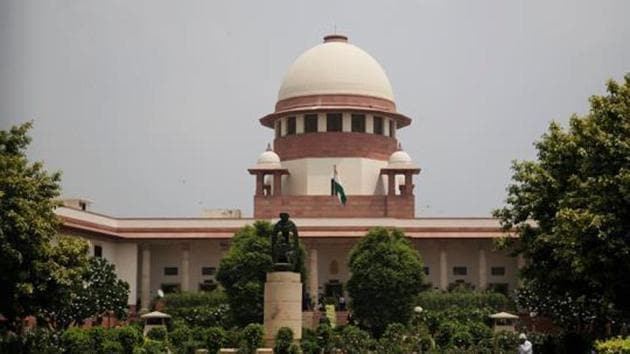 FILE - In this Aug. 22, 2017 file photo, a gardener works in the lawns of the Supreme Court in New Delhi, India. India's main opposition parties sought Friday, April 20, 2018, to impeach the country's top judge, accusing him of misuse of authority and acting under government pressure. (AP Photo/Altaf Qadri, File) (AP) FILE - In this Aug. 22, 2017 file photo, a gardener works in the lawns of the Supreme Court in New Delhi, India. India's main opposition parties sought Friday, April 20, 2018, to impeach the country's top judge, accusing him of misuse of authority and acting under government pressure. (AP Photo/Altaf Qadri, File) (AP)