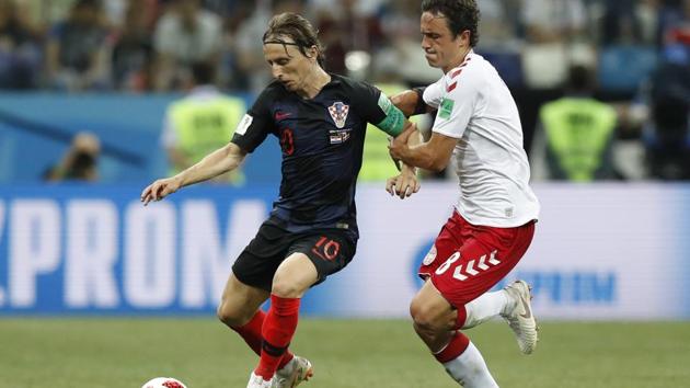 Croatia's Luka Modric, left, and Denmark's Thomas Delaney challenge for the ball during the round of 16 match. (AP) 